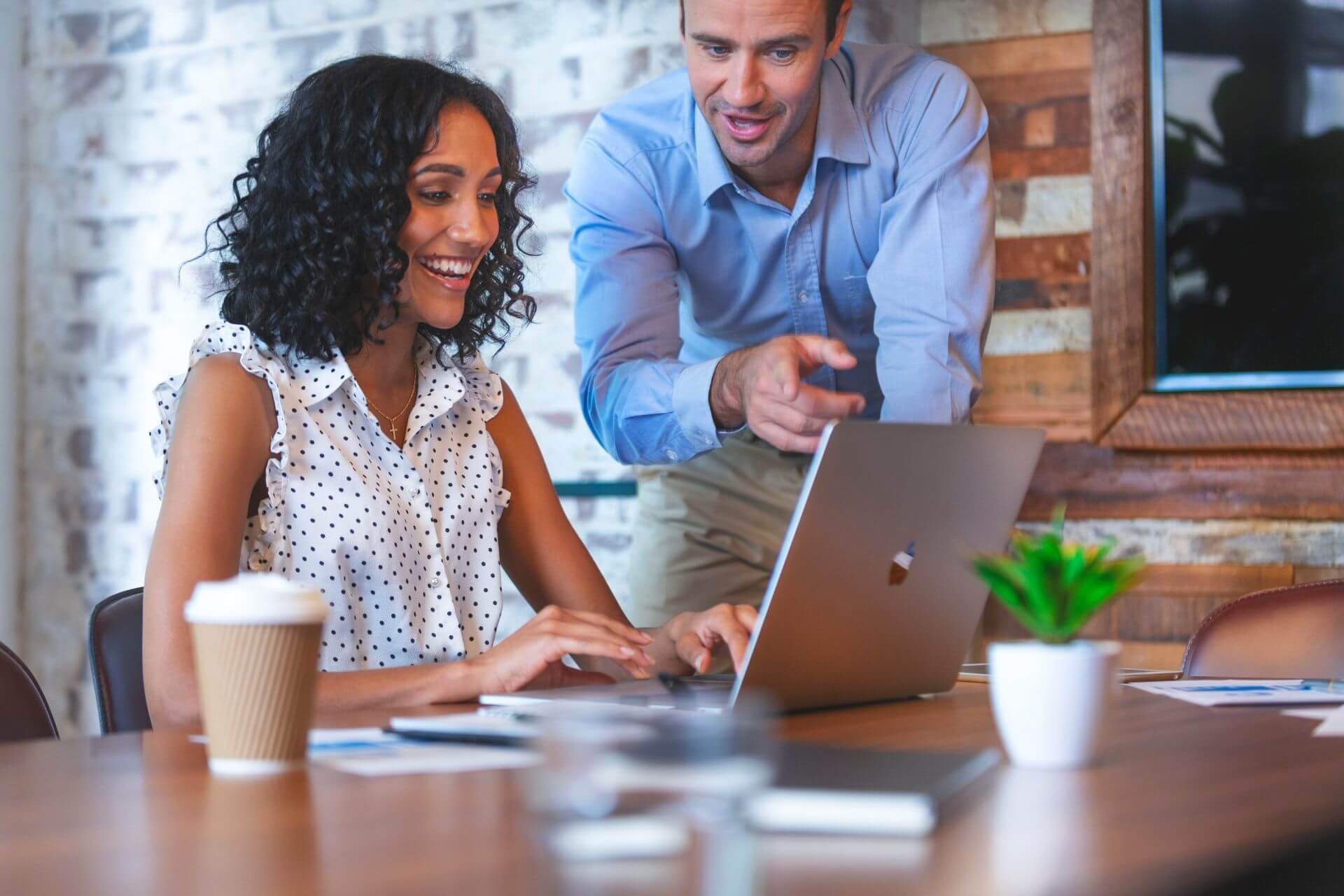 MBA Student and Mentor writing an MBA letter of recommendation together at a laptop